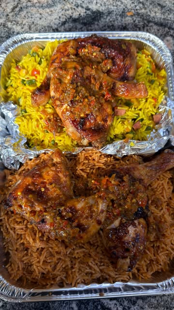 Large foil catering trays of jollof and fried rice, each topped with peppered chicken quarters, packed for an event